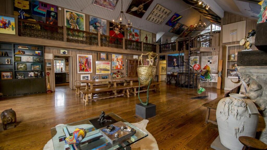 Interior of the Di Rosa Center for Contemporary Art showcasing diverse contemporary artworks, sculptures, and installations displayed throughout a spacious gallery with hardwood floors and high ceilings.