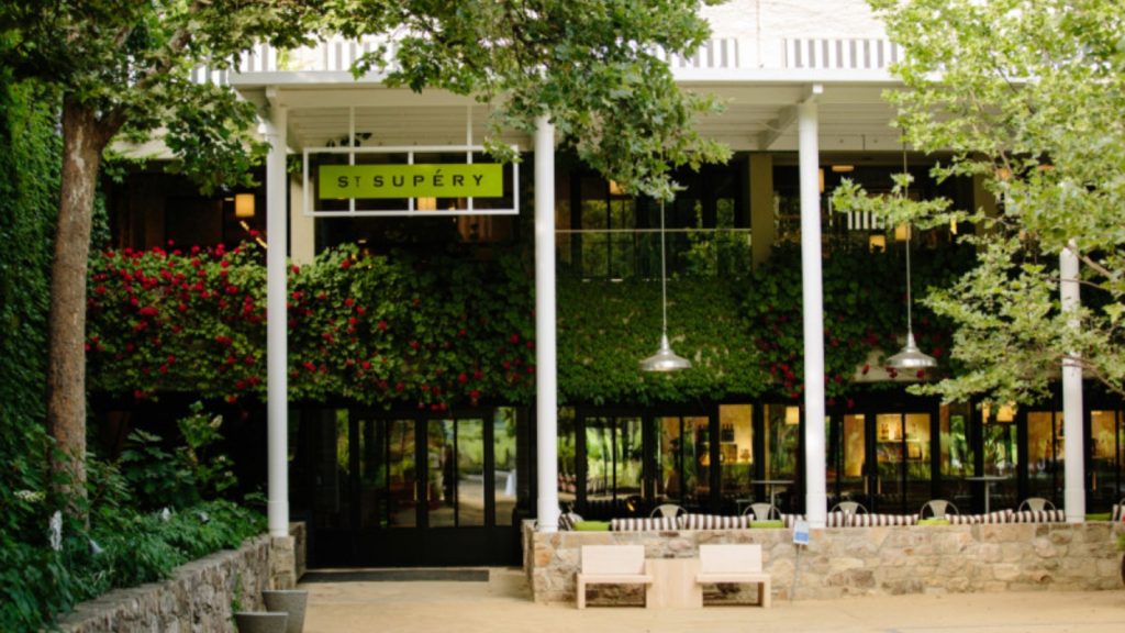 Mustard Season Tasting Flights at St. Supéry Estate Vineyards & Winery featuring white colonnade entrance with vertical garden and outdoor patio seating