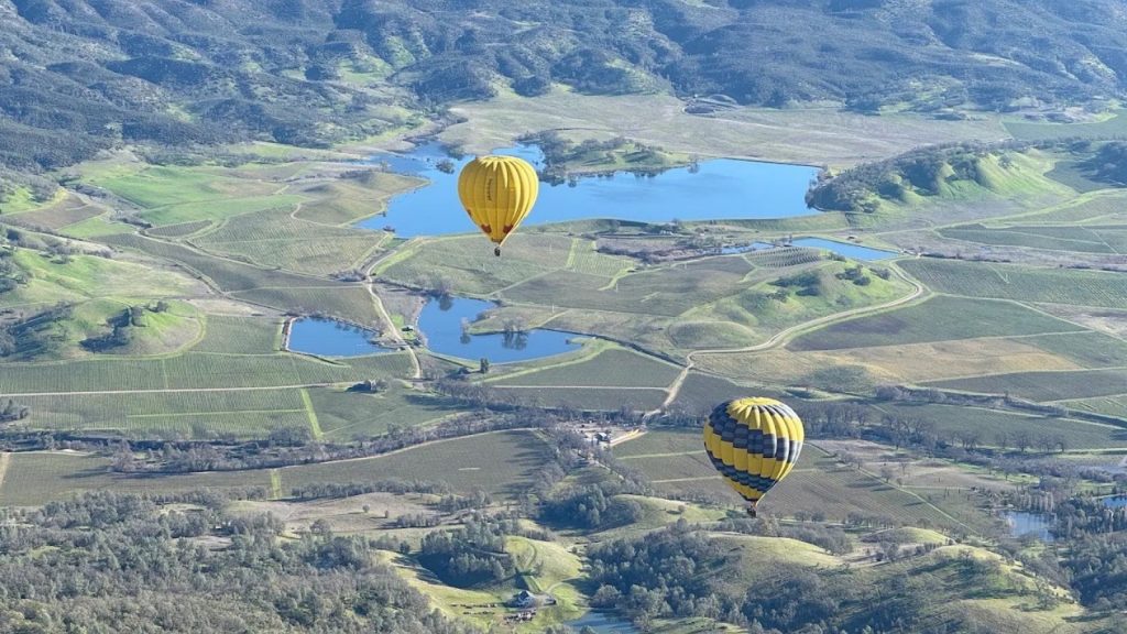 Hot air Napa Valley Aloft balloons flying over rolling hills