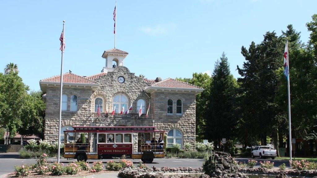 Sonoma Plaza with historic city hall and wine trolley passing by