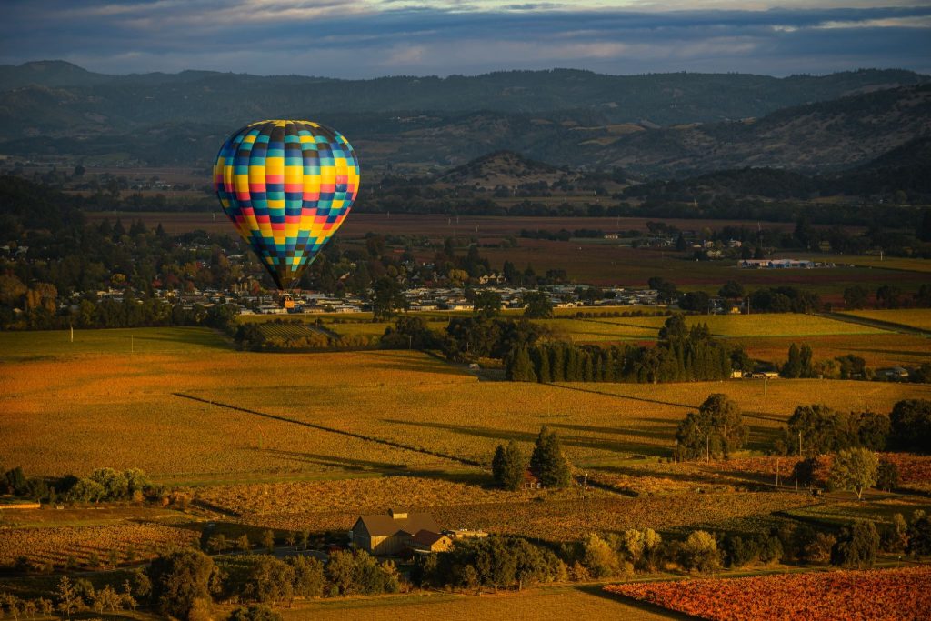 Hot air balloon over Napa Valley vineyards during sunrise day trip from San Francisco