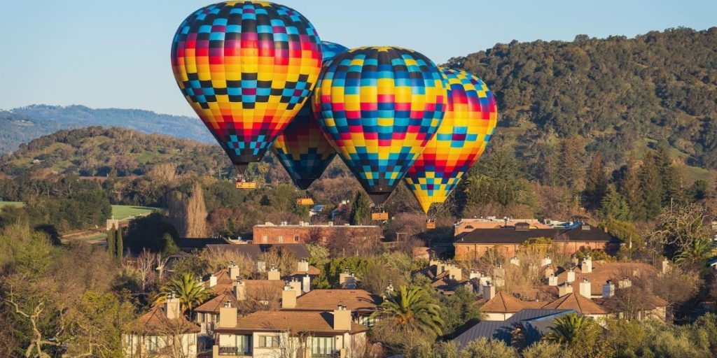 Colorful Napa Valley Aloft hot air balloons flying over Yountville vineyards in June